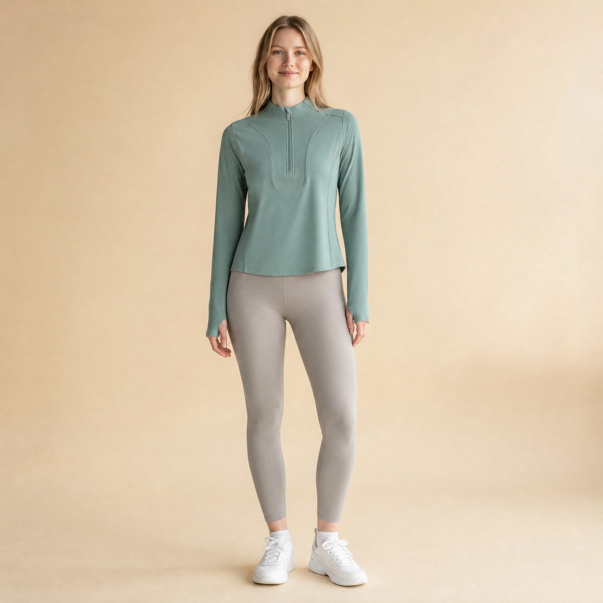Women's quarter-zip long-sleeve athletic top, front view with stand collar and ribbed front panel